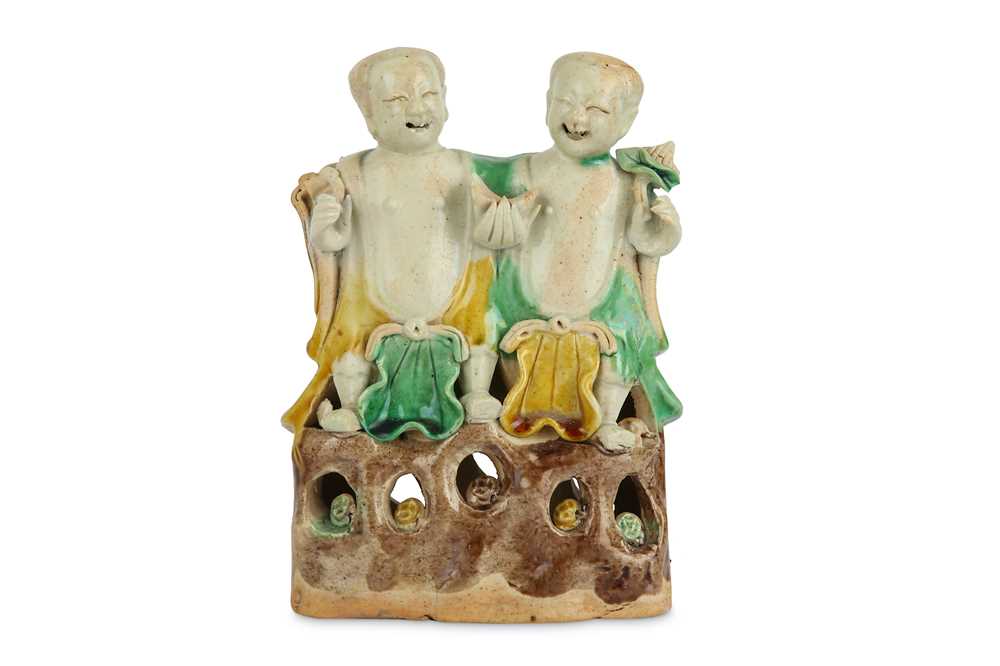 Lot 52 - A CHINESE SANCAI-GLAZED BISCUIT MODEL OF THE TWINS HEHE ERXIAN.