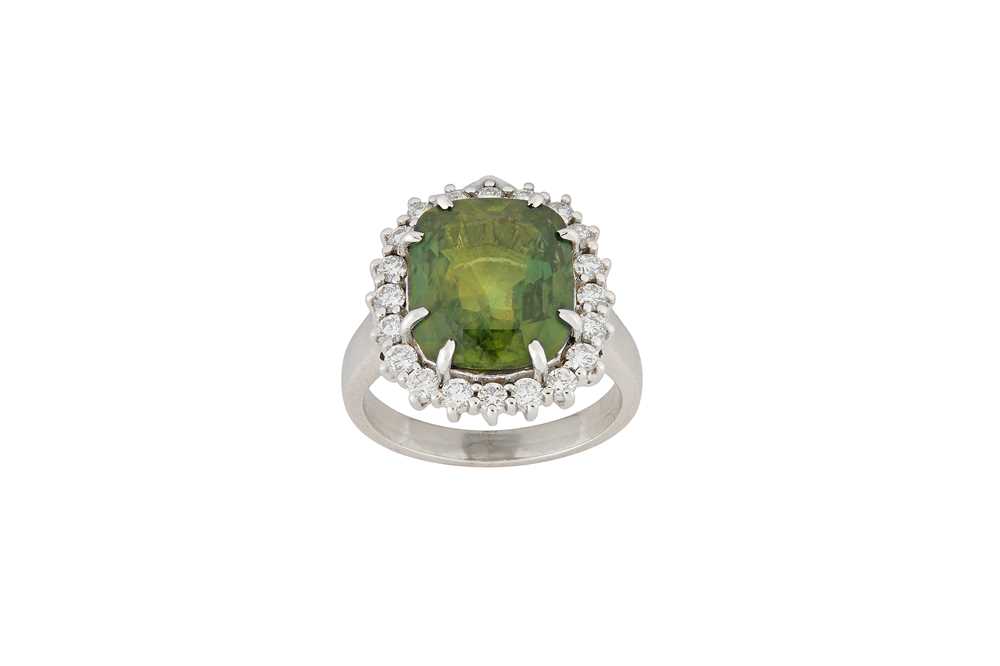 Lot 25 - A green sapphire and diamond cluster ring  The...