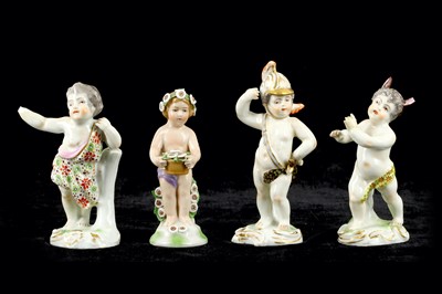 Lot 115 - A group of four porcelain cherub figures in...