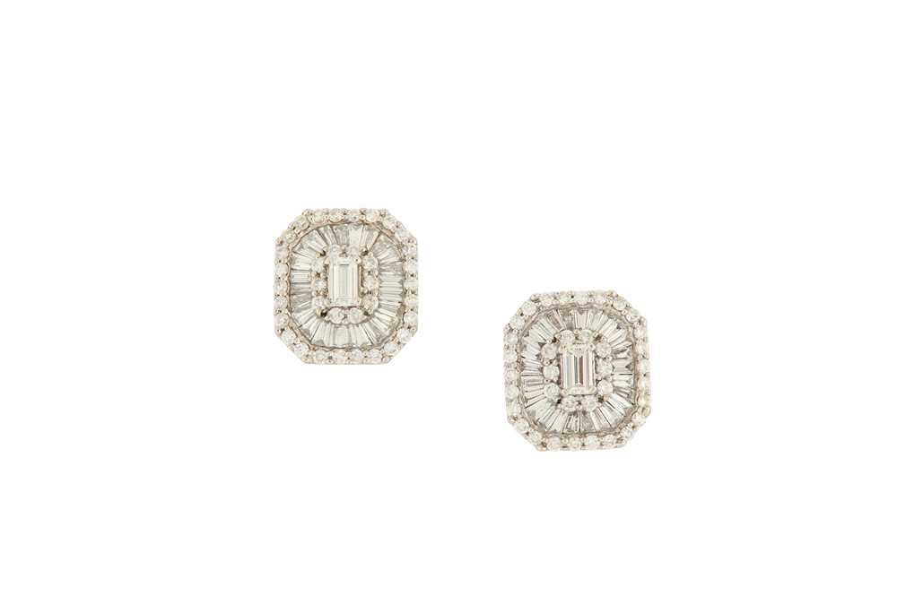 Lot 89 - A pair of diamond cluster earrings The central...
