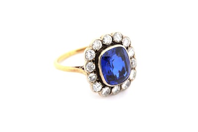 Lot 12 - A synthetic sapphire and diamond cluster ring,...