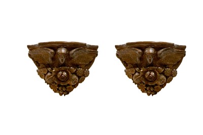 Lot 424 - A pair of carved oak sconces with eagle heads....