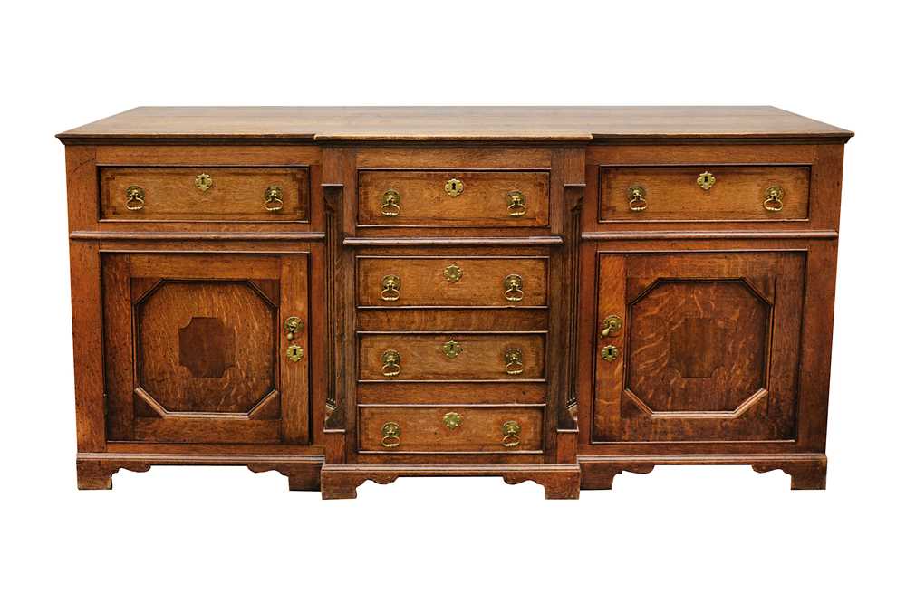 Lot 346 - A George III oak breakfront dresser, with...