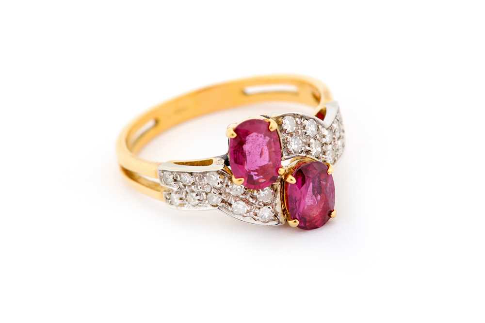 Lot 28 - A garnet and diamond dress ring, of crossover...