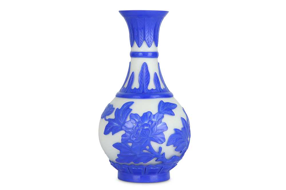 Lot 286 - A Chnese Pekng glass blue overlay 'peony' bottle vase.