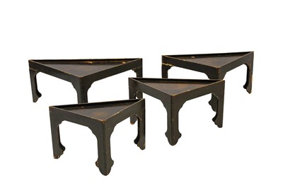 Lot 435 - A nest of four triangular lacquered low tables....