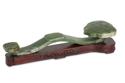Lot 312 - A Chinese celadon 'elephant wth a vase' jade ruyi sceptre.