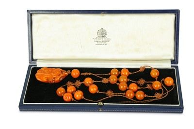 Lot 187 - A CHINESE AMBER 'DOUBLE GOURD' NECKLACE.  Qing...