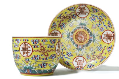 Lot 483 - A CHINESE FAMILLE ROSE YELLOW-GROUND 'BIRTHDAY' CUP AND SAUCER.