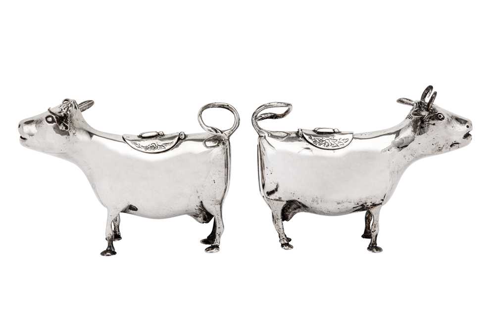 Lot 228 - A matched pair of late 19th century / early 20th century German 800 standard silver cow creamers, Hanau circa 1900