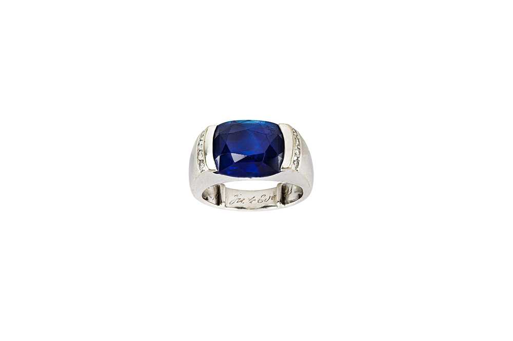Lot 79 - A sapphire and diamond ring The cushion-shaped...