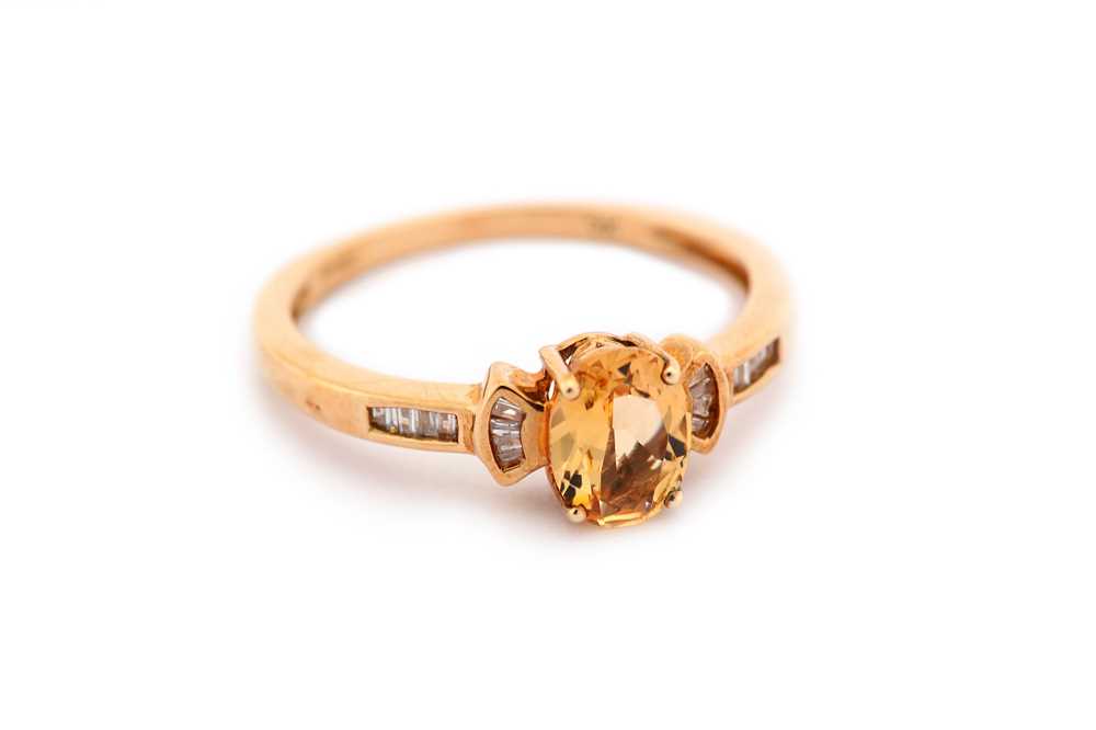 Lot 19 - A topaz and diamond ring, the oval-cut orange...