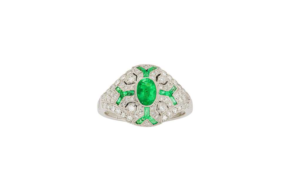 Lot 180 - An emerald and diamond dress ring The oval-cut...