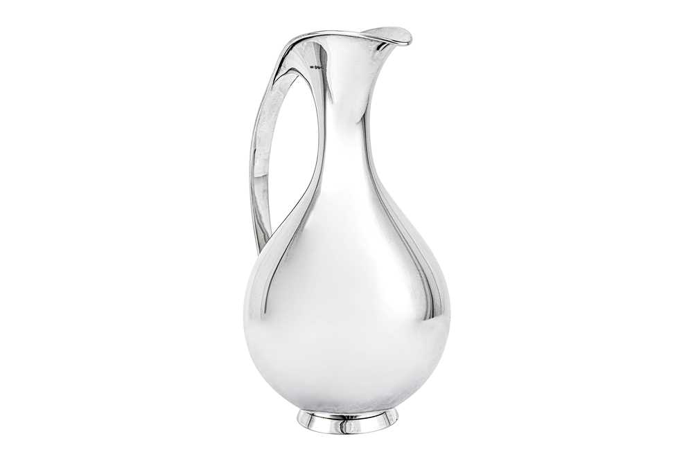 Lot 277 - A mid-20th century Danish sterling silver water pitcher / ewer, Copenhagen 1959 designed by Kay Fisker (1893-1965) for Anton Michelson
