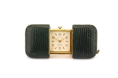 Lot 47 - HERMES. A GOLD PLATED AND LEATHER TRAVEL WATCH...