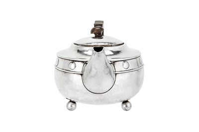 Lot 526 - A George V sterling silver ‘arts and crafts’ teapot, Birmingham 1923 by A. E. Jones