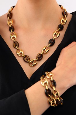 Lot 109 - A set of gold and tiger's eye interlocking bracelets / necklace, 1973