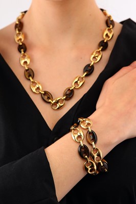Lot 109 - A set of gold and tiger's eye interlocking bracelets / necklace, 1973