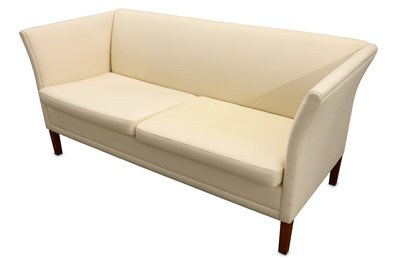 Lot 609 - A Danish two seater sofa with cream fabric upholstery