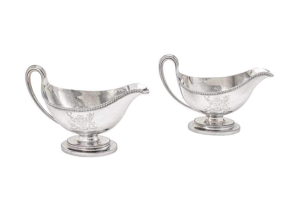 Lot 576 - A pair of George III sterling silver sauce boats, London 1784 by Edward Wakelin and William Taylor (reg. 25th Sep 1776)