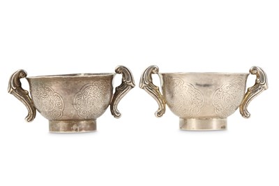 Lot 567 - A PAIR OF CHINESE SILVER TEA CUPS.