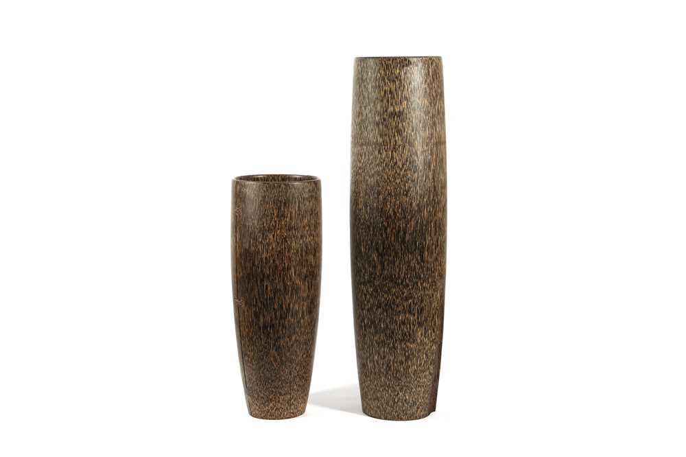 Lot 557 - A graduated pair of exotic hardwood vases