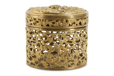 Lot 394 - A CHINESE GILT-BRONZE RETICULATED 'MYTHICAL BEASTS' BOX AND COVER.
