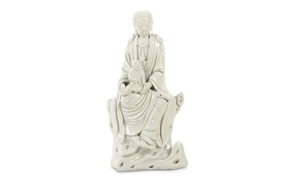 Lot 307 - A CHINESE BLANC-DE-CHINE FIGURE OF GUANYIN AND CHILD.