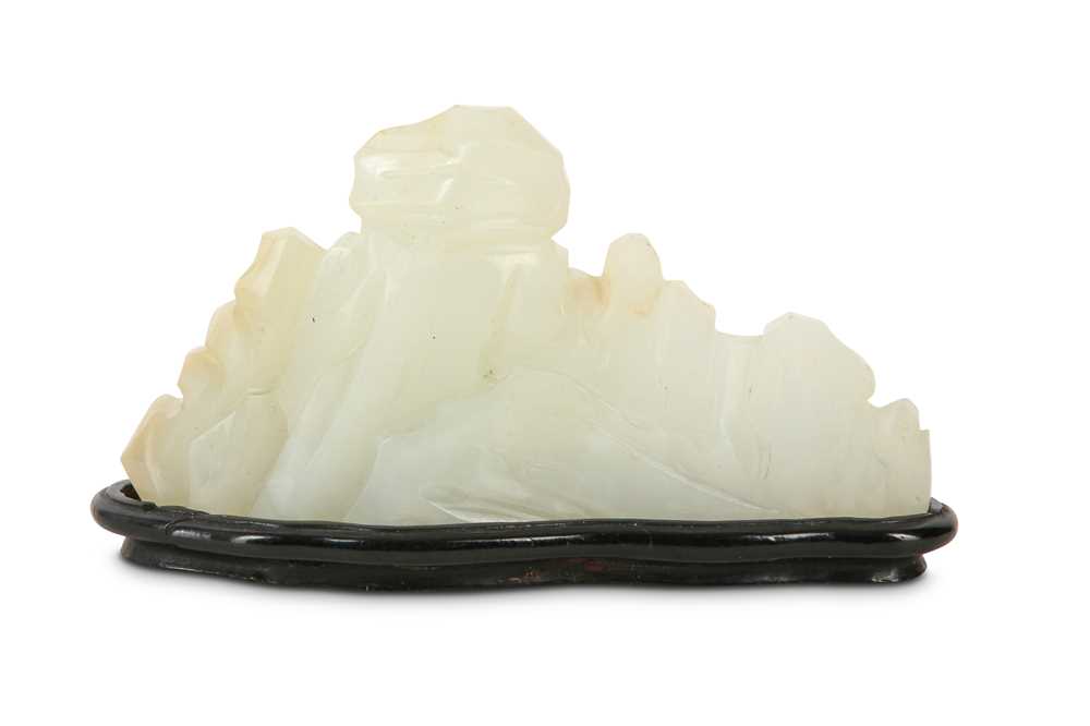 Lot 56 - A CHINESE WHITE JADE 'MOUNTAIN' BRUSH REST.