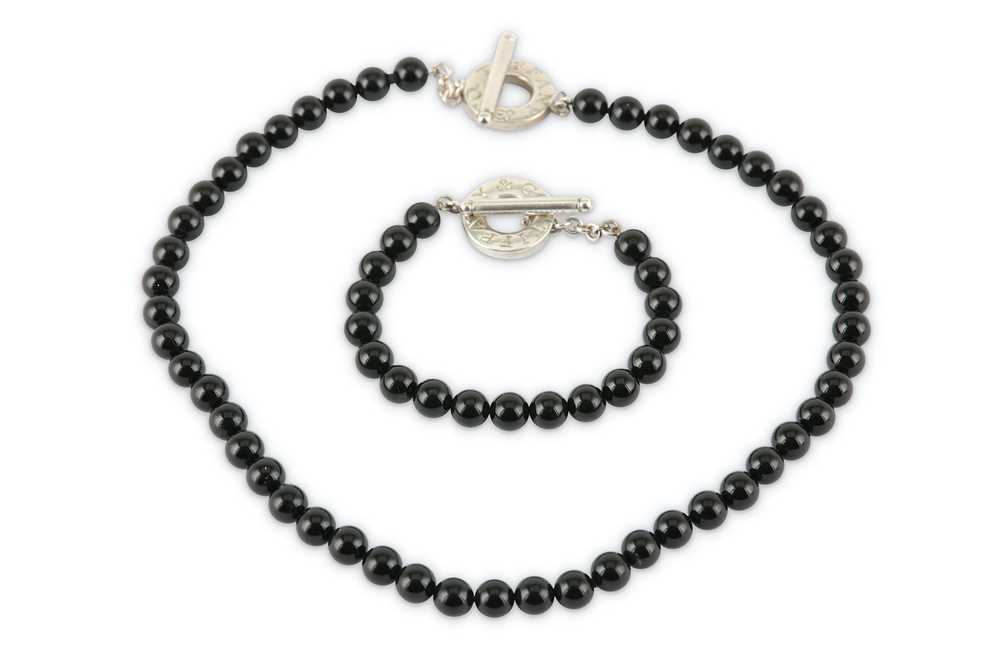 Lot 127 - An onyx bead necklace and bracelet suite, by Tiffany & Co.