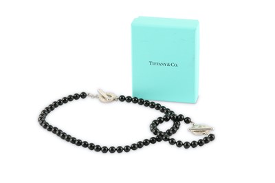 Lot 127 - An onyx bead necklace and bracelet suite, by Tiffany & Co.