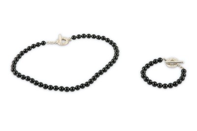 Lot 127 - An onyx bead necklace and bracelet suite, by Tiffany & Co.