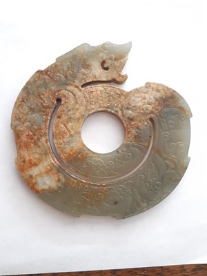 Lot 701 - A CHINESE PALE CELADON JADE SPIRAL 'DRAGON' PLAQUE.