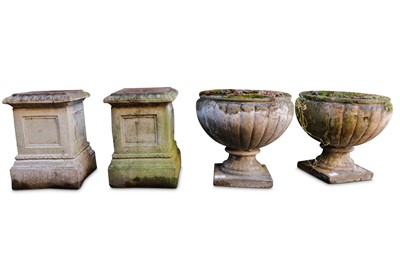Lot 569 - A pair of reconstituted stone garden planters and plinths