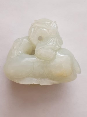 Lot 702 - A CHINESE WHITE JADE 'BOY AND RAM' CARVING.