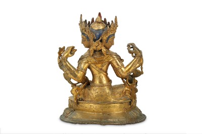 Lot 448 - A CHINESE GILT-BRONZE SEATED FIGURE OF THREE-FACED VASUDHARA.