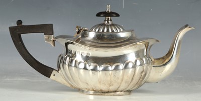 Lot 36 - A hallmarked silver teapot of gadrooned melon...