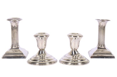 Lot 166 - A pair of American sterling silver dwarf candlesticks