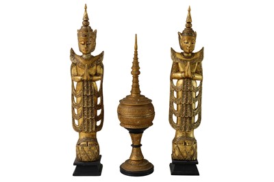 Lot 330 - A pair of late 20th Century carved gilt wood Thai Buddhist figures