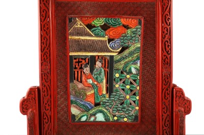 Lot 205 - A Chinese porcelain plaque inlaid cinnabar lacquer table screen.