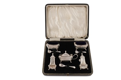 Lot 23 - An Edwardian cased sterling silver cruet set