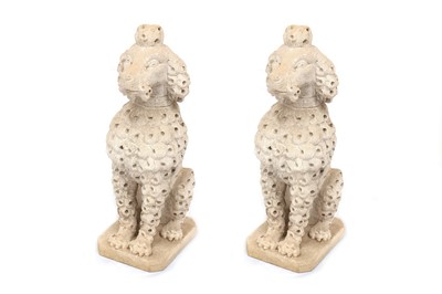 Lot 773 - A pair of weathered reconstituted stone garden figures of poodles