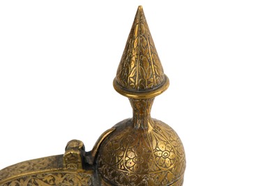 Lot 320 - A QAJAR SILVER-INLAID BRASS EWER