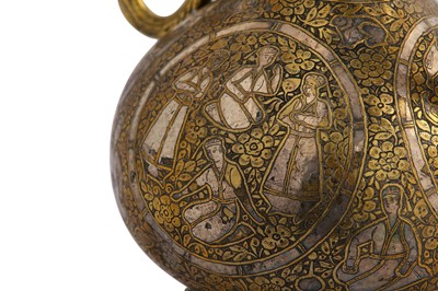 Lot 320 - A QAJAR SILVER-INLAID BRASS EWER