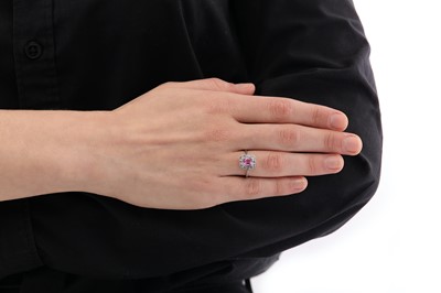 Lot 66 - A pink sapphire and diamond cluster ring