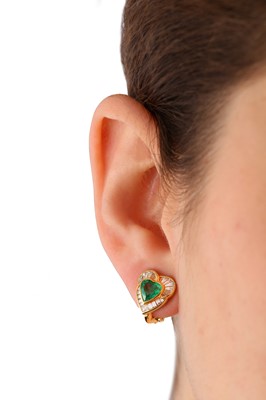Lot 119 - A pair of emerald and diamond earclips, by H. Stern