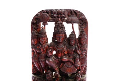 Lot 228 - A CARVED SANDALWOOD ICON OF VISHNU AND HIS CONSORT
