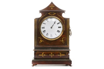 Lot 104 - An Empire brass inlaid mantle clock
