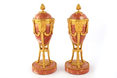 Lot 102 - A pair of 19th Century French ormolu mounted rouge marble urns