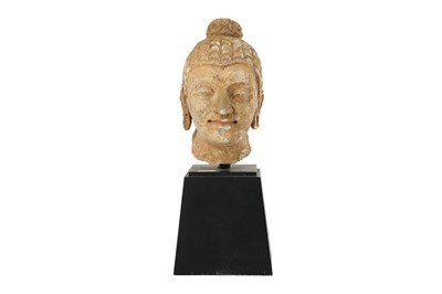 Lot 181 - A STUCCO BUDDHA HEAD WITH RED PIGMENT RESIDUES